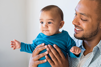 Young mother using smartphone while nursing infant